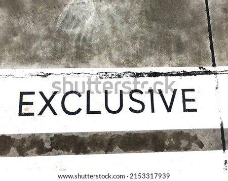 The word exclusive image on the cement floor, texture pattern background