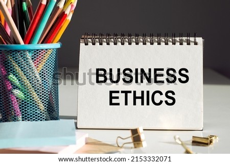 BUSINESS ETHICS text on sticky with office tools