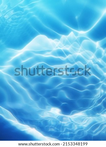 Closeup​ blur​ abstract​ of​ surface​ blue​ water. Abstract​ of​ surface​ blue​ water​ reflected​ with​ sunlight​ for​ background. Blue​ sea. Blue​ water.​ Water​ splashed​ for​ abstract​ background.