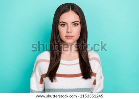 Photo of serious confident woman wear striped sweater smiling isolated turquoise color background