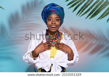 Photo of excited masai lady impressed wear native tribal accessories headwrap isolated blue colored background