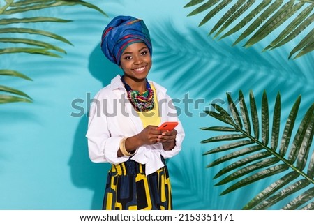 Photo of lady blogger wear savanna dress headwrap accessories use device in rain forest isolated teal color background