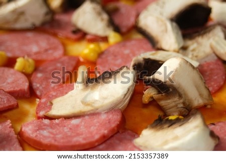 Defocus closeup ingredients for pizza on dough. Red tomato sauce, sausages, sweet corn. Homemade italian pizza. Home culinary. Blurred. Italian cuisine background. Copy space. Backdrop. Out of focus.