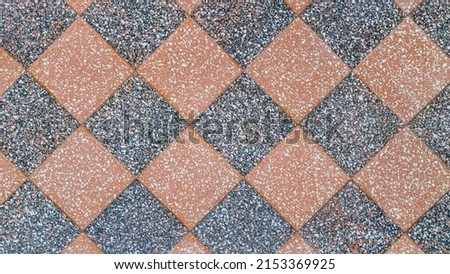 Checkered stone covering top view. Spotted checkered stone
 texture and background