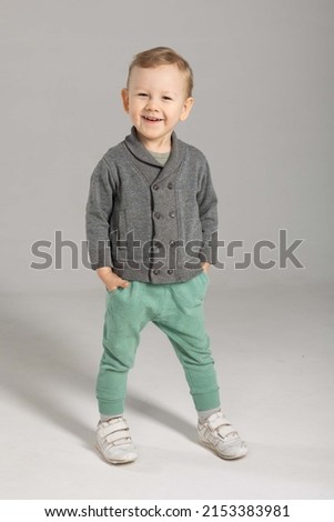 a 3-year-old boy in a gray jacket  Royalty-Free Stock Photo #2153383981