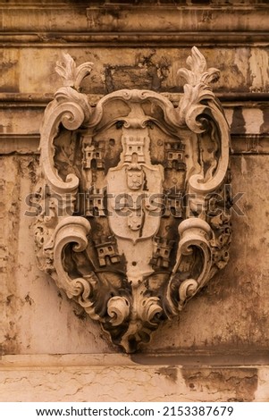 Stone ancient heraldic coat of arms on the wall Royalty-Free Stock Photo #2153387679
