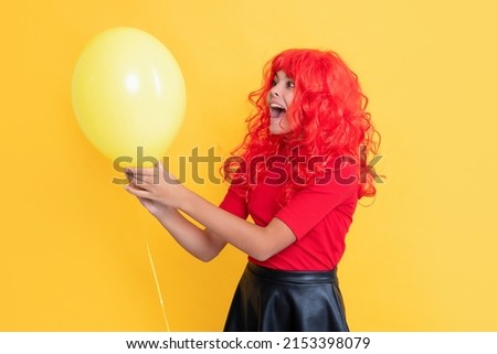 happy girl with party balloon on yellow background. wow