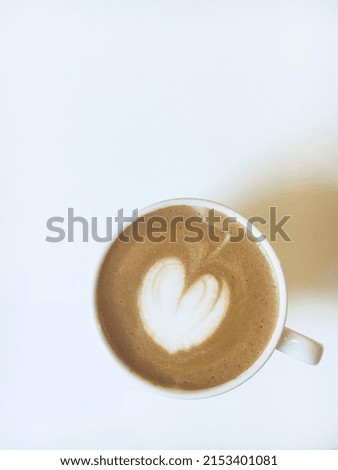 White cup of hot cappuccino on a white background. Late art.Сoffee history
