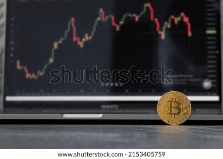 Crypto currency, blockchain or digital money concept : Golden coins, Bitcoin BTC and technical analysis, charts of financial instruments, depicts trading, investing or speculating in virtual assets.