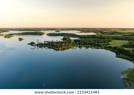 Aerial view of scenic Rubikiai lake, located near Anyksciai town, Lithuania. Beautiful landscape view from the above on summer sunset.
