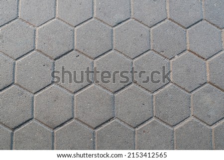 closeup of a road paved with hexagonal stones

