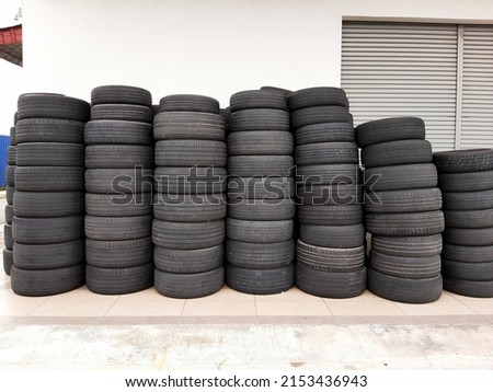 Selective focus with noise effect added picture of used tyre been stacked outside of the shop.