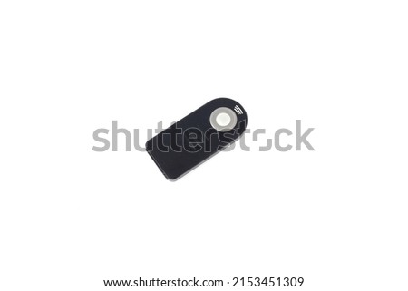 Remote control clicker button isolated against a white background. Black infrared push button for taking wireless photos.