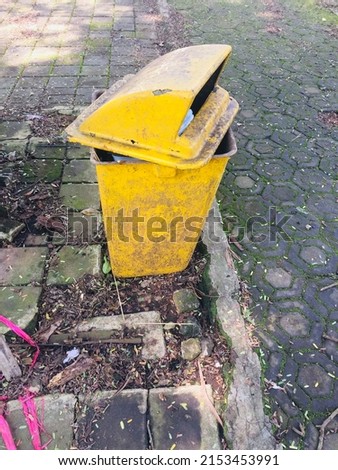 Yellow trash can in public places