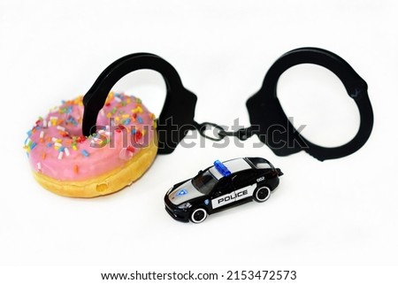 funny handcuffs with police toy car and donut 