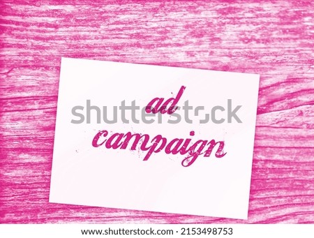 Page with text Ad Campaign and paper signs of dollar on wooden table. Business concept