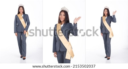 Full length Portrait of 20s Asian business Woman as Miss Beauty Pageant Contest in black short hair white shirt gray suit pant shoes. Female wear sash diamond winner crown, white Background isolated Royalty-Free Stock Photo #2153502037