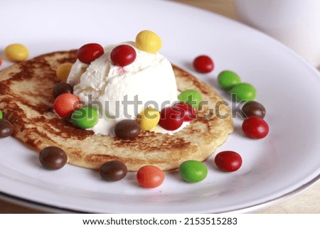 rainbow chocolate pancakes with vanilla ice cream