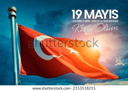 Turkey flag waving in the wind over cloudy sky during sunrise. 19 Mayis Ataturk'u Anma, Genclik ve Spor Bayrami Kutlu Olsun. English: "May 19, Happy Commemoration of Ataturk, Youth and Sports Day. Royalty-Free Stock Photo #2153518215