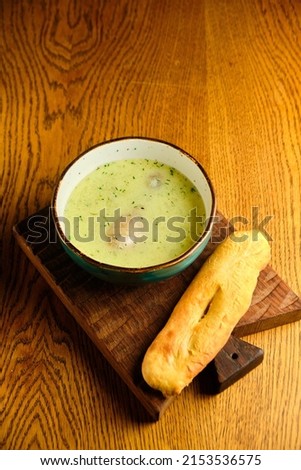 Peas soup in the yellow bowl on the wooden background. High quality photo