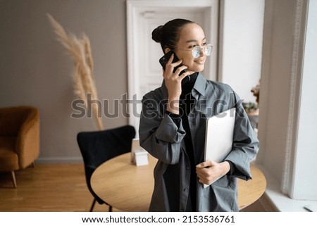 Uses phone manager freelancer Woman wearing glasses work office