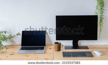 Monitor and laptop on the desk.