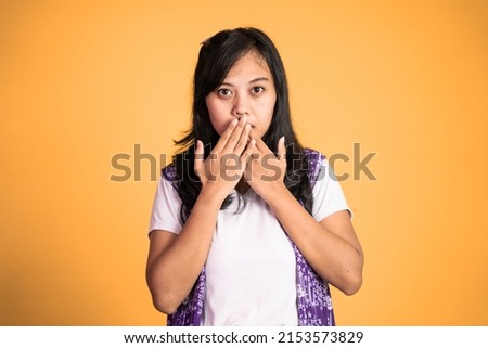 portrait of a asian woman covering her mouth with hands. concept of stop talking Royalty-Free Stock Photo #2153573829