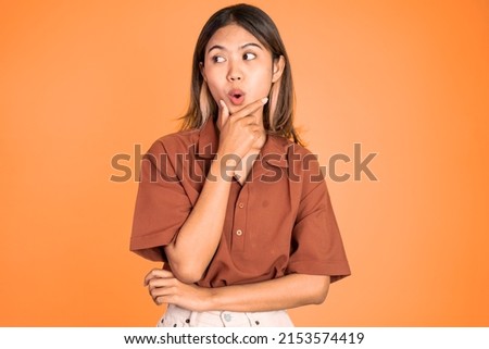 portrait of young asian woman feeling shocked and suprised over isolated background Royalty-Free Stock Photo #2153574419