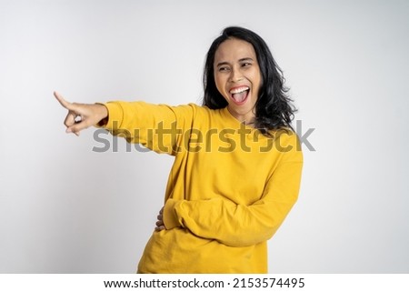 beautiful woman with finger pointing at frong and laughing at something isolated background
