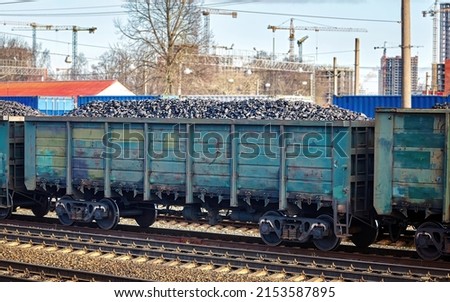 Coal freight train loaded with coal. Train transports fossil fuel. Train cars full of coal at railway station. Coal embargo, ban and restrictions concept Royalty-Free Stock Photo #2153587895