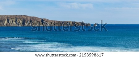 Beautiful blue sea in daylight. Rock in the blue sea. Large-format photography of the seascape.