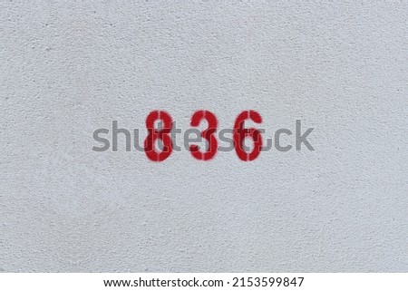 RED Number 836 on the white wall. Spray paint.
