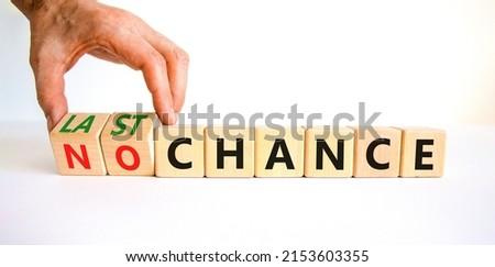 No or last chance symbol. Businessman turns wooden cubes and changes words 'no chance' to 'last chance'. Beautiful white background, copy space. Business and no or last chance concept.