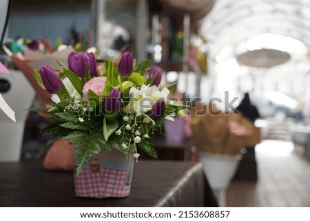 Bright bouquets of flowers with decorative paper on sale.