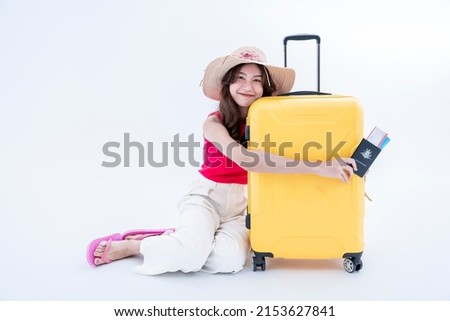 Bright young Asian women in Thailand wear a hat and hold a passport Take a picture with your luggage isolated from the white background