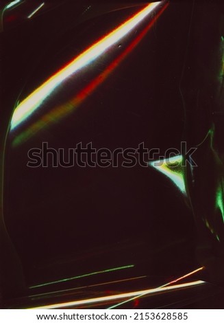 Old film overlay. Light flare noise. Retro effect filter. Neon red green white color glitch glow dust scratches defect on dark black abstract background.