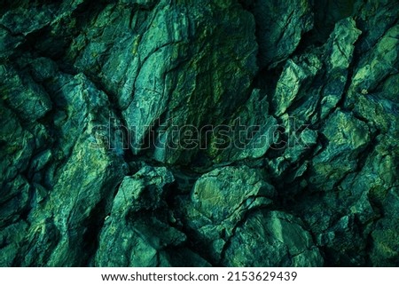    Dark green yellow rock texture. Toned rough mountain surface texture. Crumbled. Close-up. Rocky background with space for design. Fantasy.                            