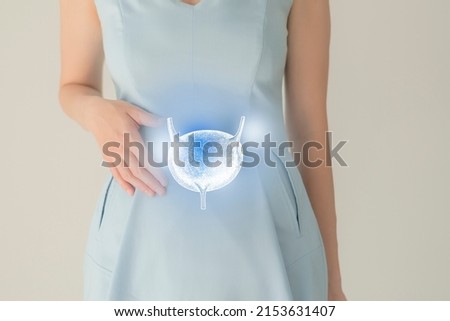 Unrecognizable female patient in blue clothes, highlighted handrawn bladder in hands. Human renal system issues concept. Royalty-Free Stock Photo #2153631407