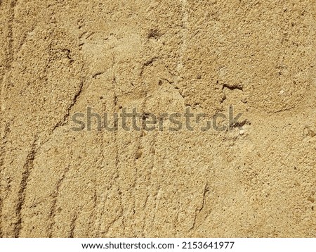 texture of a yellow sand wall worn down by time