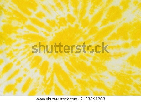 Beautiful white and yellow tie dye pattern on the fabric. The background on the fabric is made with your own hands. Flat lay. Royalty-Free Stock Photo #2153661203