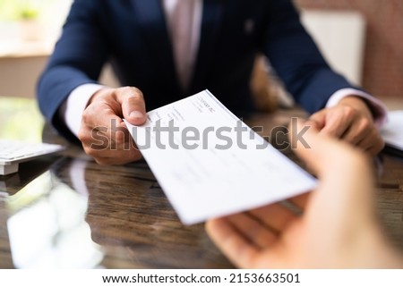 Hand Giving Payroll Compensation Paycheck. Salary Cheque Royalty-Free Stock Photo #2153663501