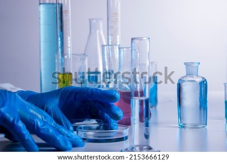 Hand of a scientist taking samples with a pipette
