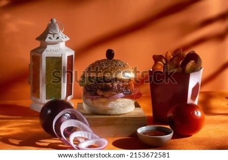 BBQ chicken cheese burger with french fries, potato and tomato slice isolated on wooden board side view on table fast food