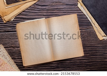 vintage paper sheets, old checkered notebooks, retro design notepad on wooden background