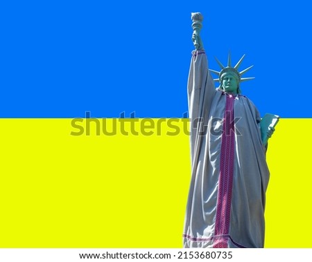 The Statue of Liberty wearing Ukrainian embroidered shirt against flag of Ukraine as symbol of the struggle of Ukrainian people for values of freedom and democracy against the russian aggressor.