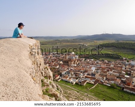 Man admiring vast landscape of Castile La Mancha from castle in Penas de San Pedro. Albacete, Spain. High quality photo