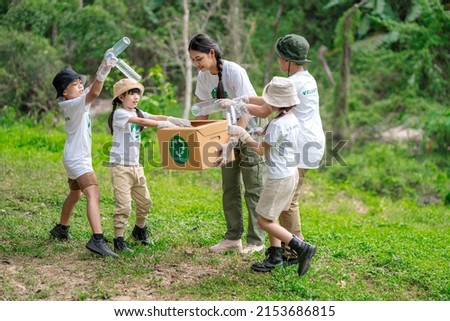 Volunteer Asian and children are collecting plastic bottles into garbage box to reduce global warming and environmental pollution. Volunteering and recycling concept.
 Royalty-Free Stock Photo #2153686815