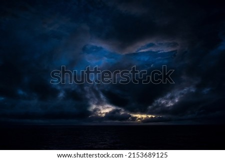 Blue face in sky cloud in sky at sunset period in ocean