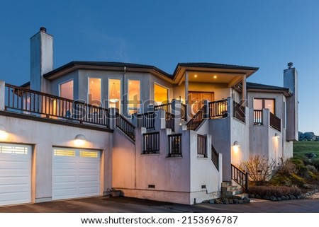 Twilight Photo of the Entry and Multi-Door Garage of a Gorgeous 4,000 sq ft Custom New Home on Private 600 Acre Lakeside Marin Property Royalty-Free Stock Photo #2153696787