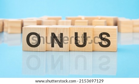 word Onus on wooden cubes on blue background. the inscription on the cubes is reflected from the surface. business concept
